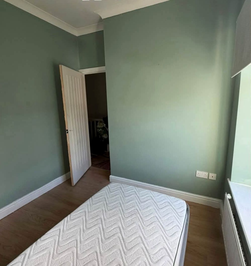 Same bedroom painted sage green with white woodwork
